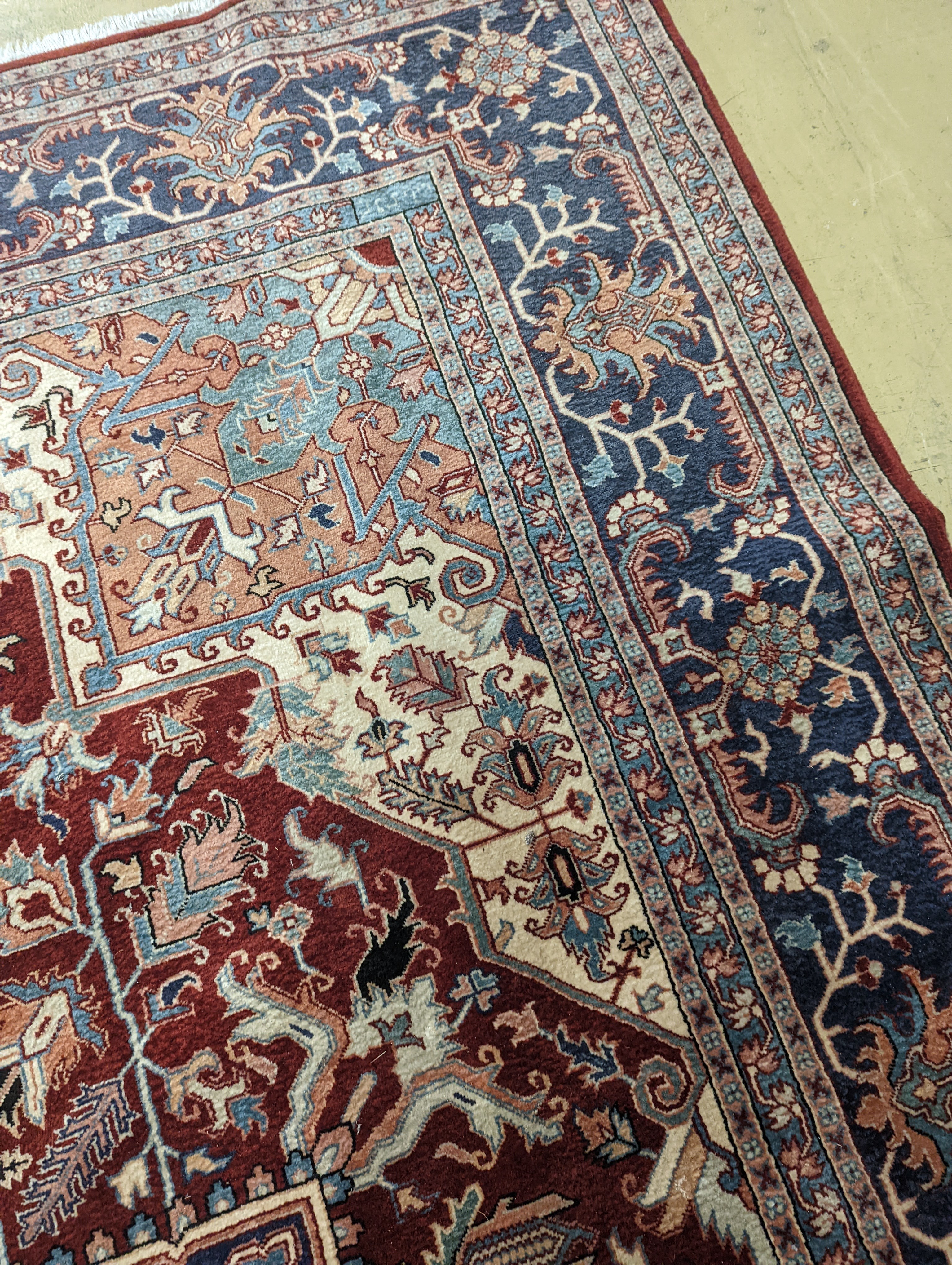 A large Caucasian style red ground carpet, 460 x 330cm